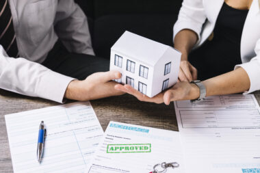 Real estate agent reviewing professional indemnity insurance documents at the office.