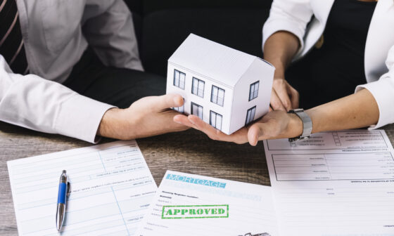 Real estate agent reviewing professional indemnity insurance documents at the office.