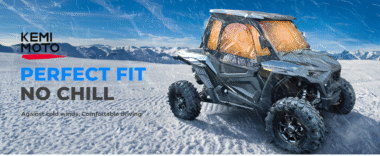 Kemimoto UTV with cab enclosure driving in snowy mountains, providing warmth and wind protection for comfortable off-road riding.