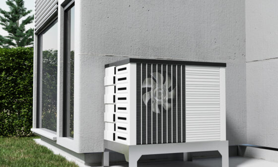 Air source heat pump outdoor unit beside a modern home